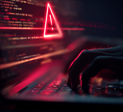 A close-up of a person typing on a laptop